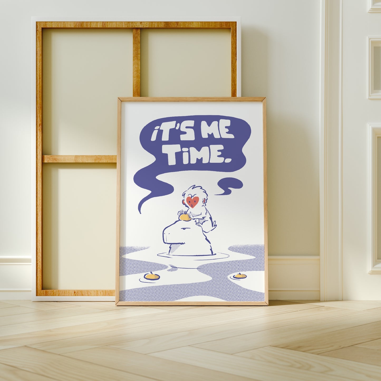 Extra Large frame next to canvas of the capybara and snow monkey print leaning against a wall on a wooden floor