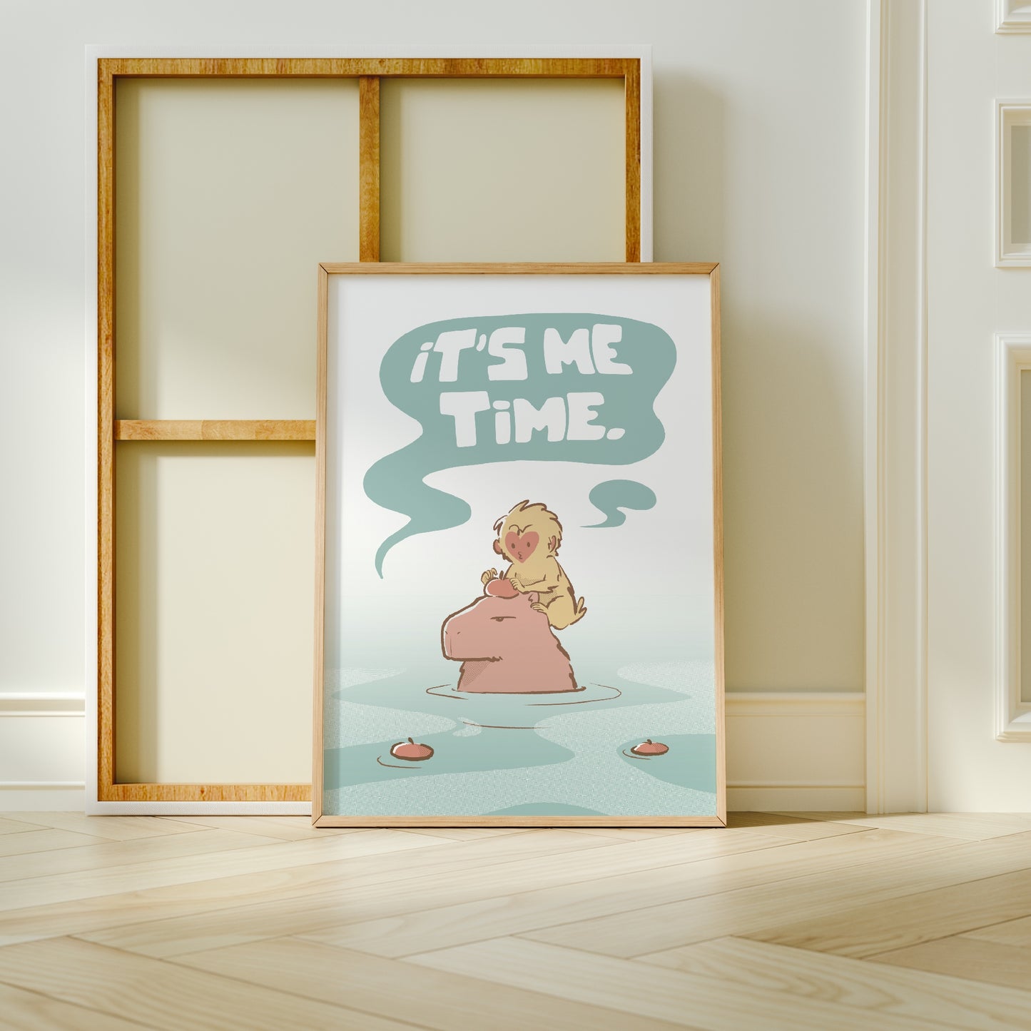 Extra Large frame next to canvas of the capybara and snow monkey (Jade) print leaning against a wall on a wooden floor