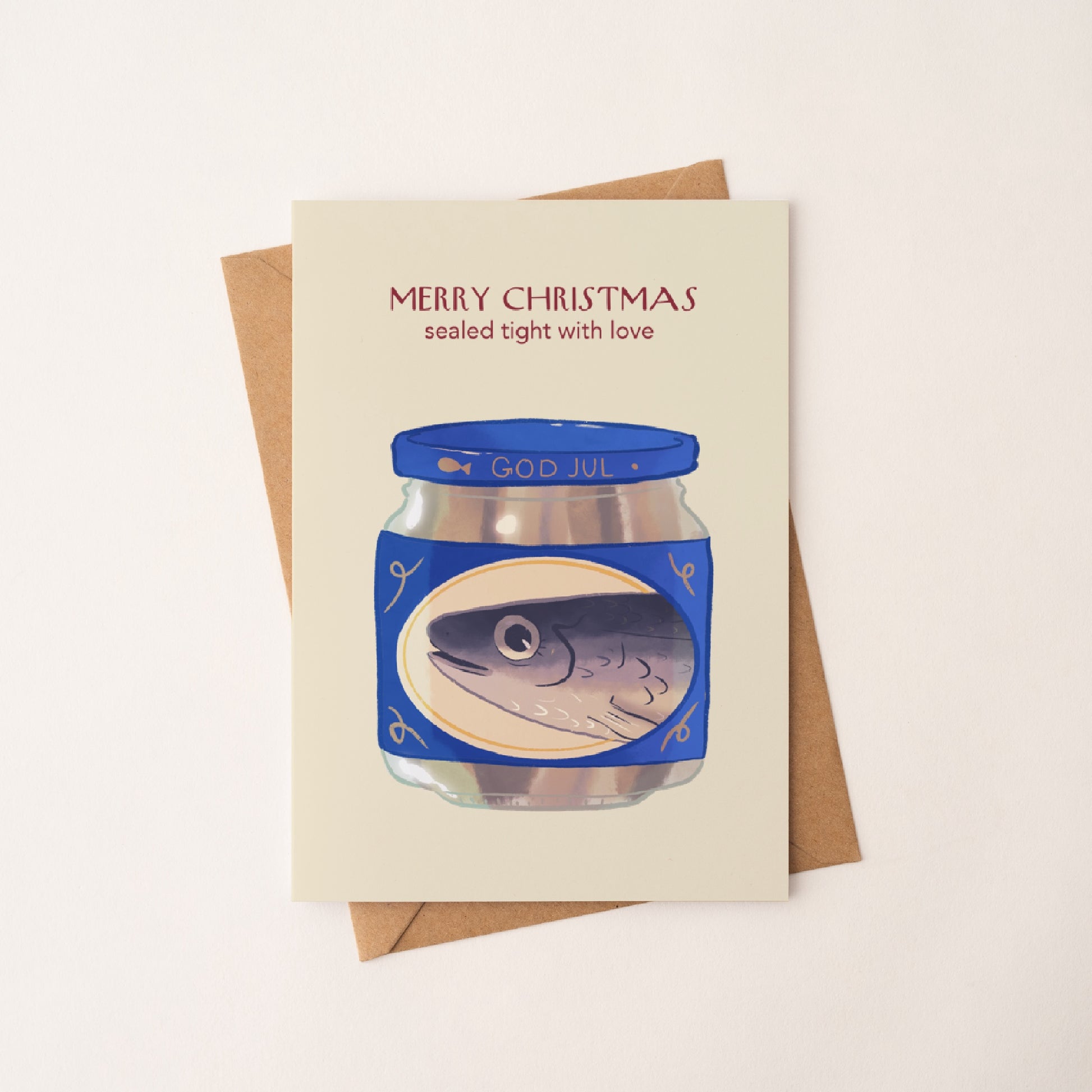 Christmas card of pickled herring jar on a kraft envelope in diagonal