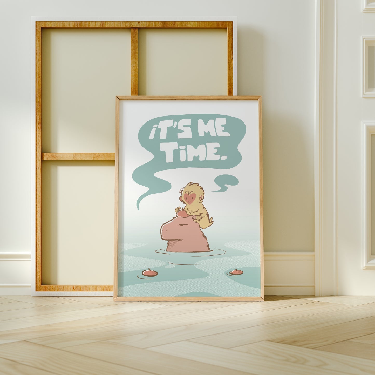 Extra Large frame next to canvas of the capybara and snow monkey (Jade) print leaning against a wall on a wooden floor 