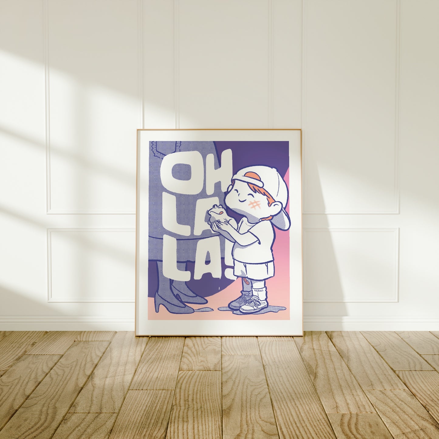 Large frame of the Oh La La ! poster leaning against a wall on a wooden floor 